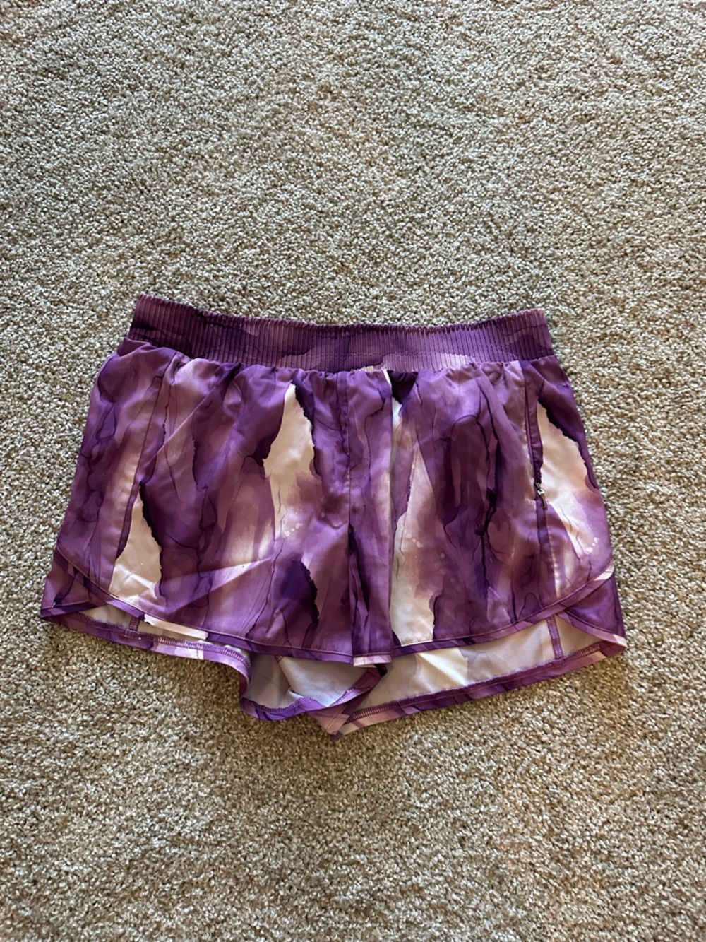 Purple running shorts with built-in lining.